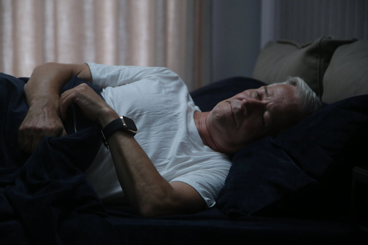 Older adult wearing YHE BP Doctor Med before bed as part of a nighttime blood pressure routine